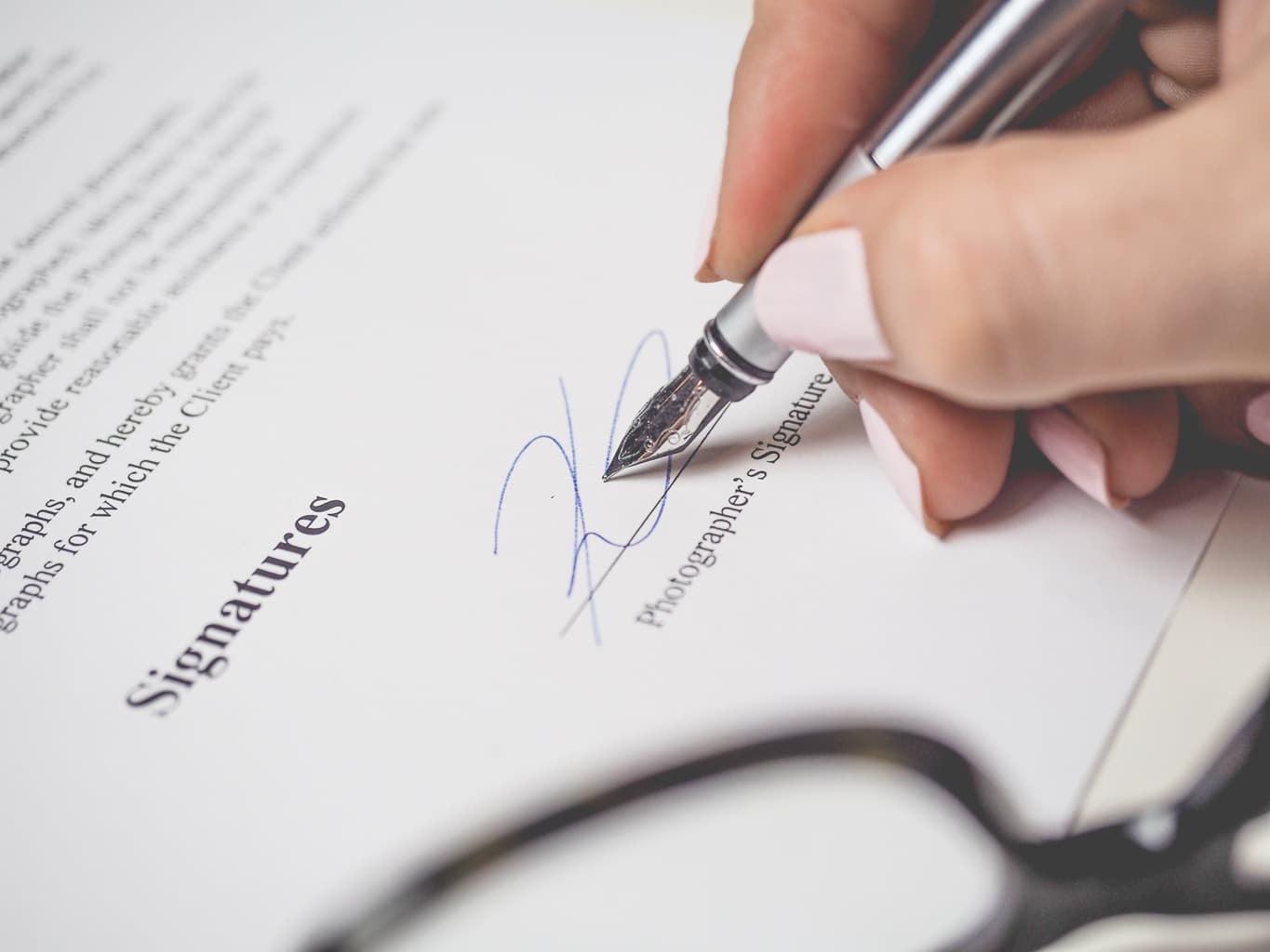 Free Person Holding Silver Pen Signing Photographers Signature Stock Photo